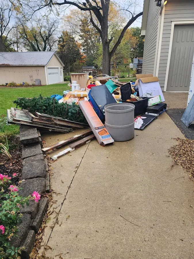 Dumpster being loaded with debris for Estate Cleanout Dumpster Rental in Baldwin Park